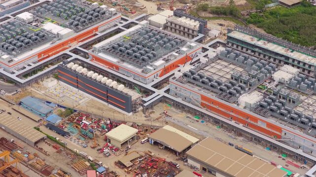 Vast aerial perspective of a cutting edge hyperscale data center during its construction phase, showcasing modern engineering and technology