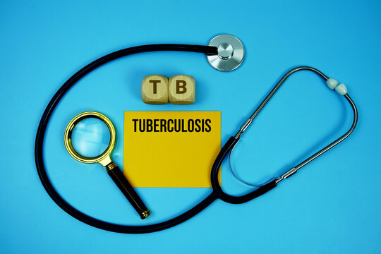 Tuberculosis (TB) text with stethoscope and magnifying glass on blue background