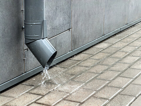 rainwater flowing from drainpipe. exterior drainage system.