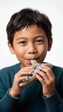 Happy Southeast Asian Boy Playing Ceramic Ocarina Instrument