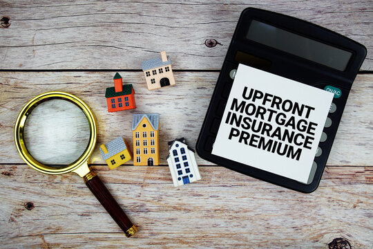 Mortgage Insurance Premium text with house model, calculator and magnifying glass on wooden background