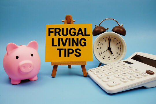 Frugal Living Tips text with piggy bank, alarm clock and calculator on blue background