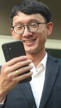 slow motion scene of business investor man using smartphone mobile for checking currency market of global trading and turn on tablet for monitoring news of money exchange