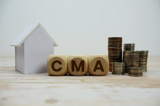 CMA (Comparative Market Analysis) text with house model and coin stack Properties and Real Estate Concept