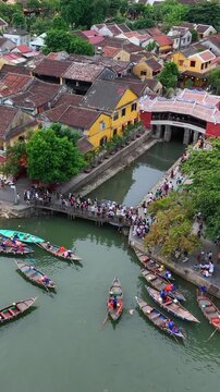 Vertical video,Drone view of Hoi An, Vietnam, during the day with many tourists.