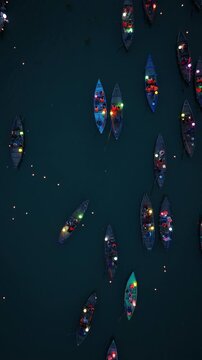 Vertical video,Drone view of Hoi An, Vietnam in Quang Nam Province is a popular tourist destination, with colorful lantern boats sailing along the river at night.