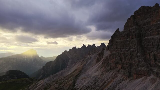 Aerial Tilt Up of Epic Dolomites Sunset with Dramatic Cliffs near Tre Cime Auronzo Misurina Italy