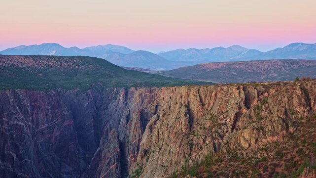 Subtle twilight colors illuminate the iconic marbled pegmatite veins of Painted Wall viewed from Warner Point in Black Canyon