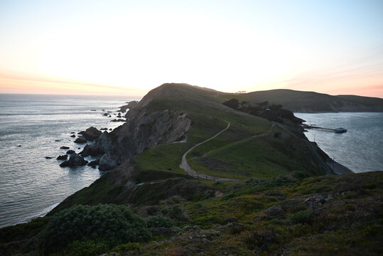 Winding coastal trail along grassy headland at sunset, Point Reyes National Seashore