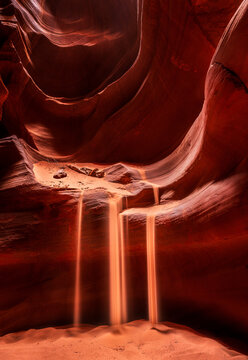 A Sand falls illuminated from the sunlight, Antelope Canyon, USA