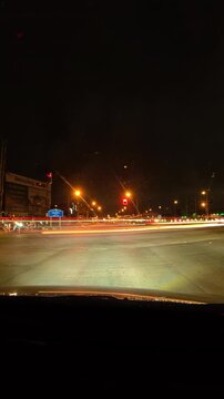 Vertical night driving footage on a highway with dramatic light trails, motion blur and illuminated traffic, creating a dynamic transportation and travel scene.