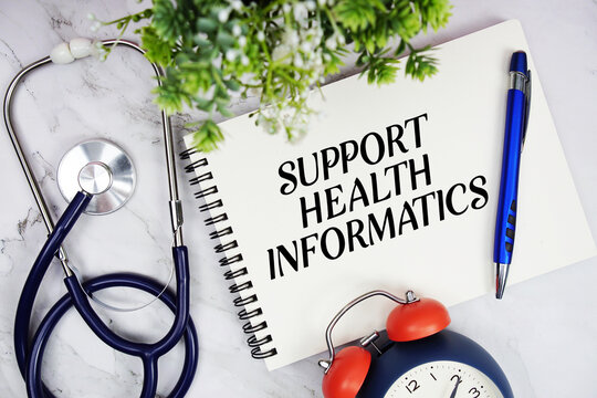 Support Health Informatics text written on notepad with stethoscope and alarm clock on marble background