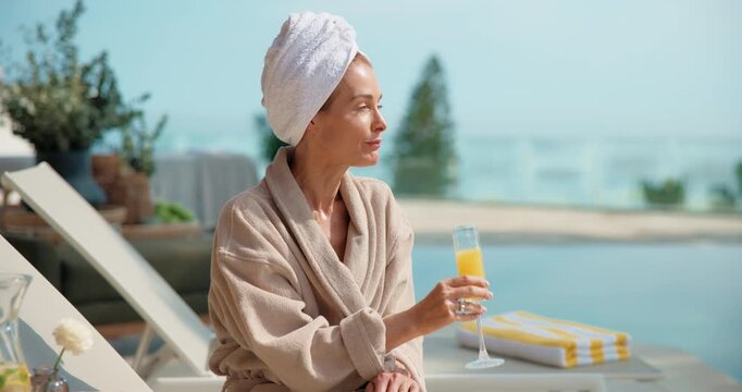 Pool, cocktail and woman at hotel for vacation, holiday and weekend getaway for me time or break. Hospitality, towel and person with mimosa, juice or drink for relax, travel view or tourism at resort