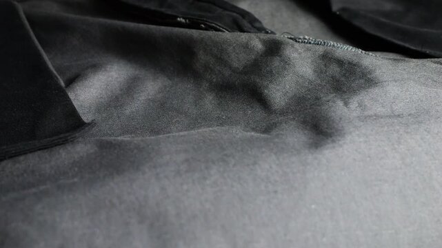 A close-up of inside-out cotton wide-leg palazzo trousers shows internal pocket details, a zipper fly on black fabric, detailed stitching, seam lines, casual baggy pants, and dark material texture.