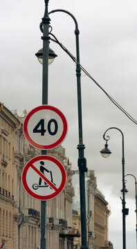 Urban Street Lamp Post With Speed Limit and No Scooter Sign