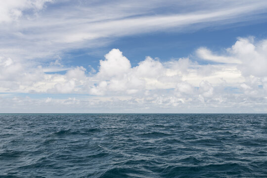 Ocean waves with turquoise water and white clouds