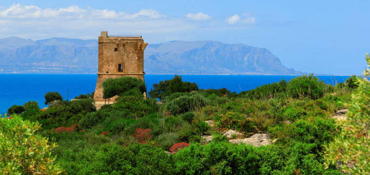 Ancient stone watch tower ruins overlooking a scenic Mediterranean sea passage and coastline