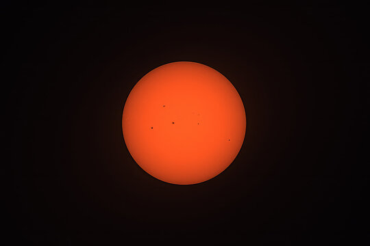 Sun with Sunspots Against Black Background