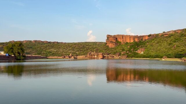 Agastya Lake in Badami, Karnataka, surrounded by historic temples and sandstone cliffs, creating a scenic view of the ancient heritage town