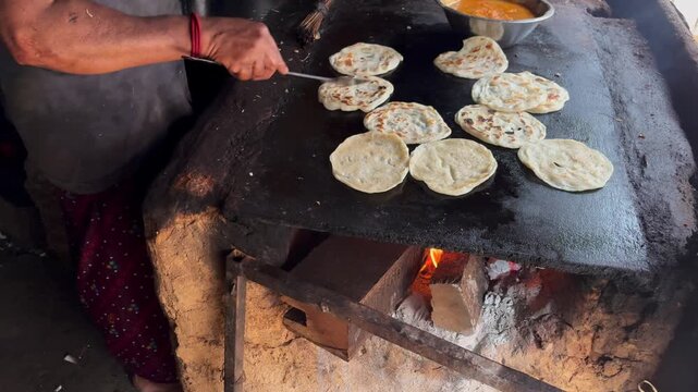 Street food vendor preparing traditional Kerala porotta at a roadside food stall, showcasing skilled hand preparation and local culinary culture