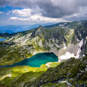 Bliznaka (the Twin), one of the Seven Rila lakes, and Haramiyata peak behind it. View from the most popular viewpoint, Ezeren peak. Summer landscape in bulgarian Rila mountains.