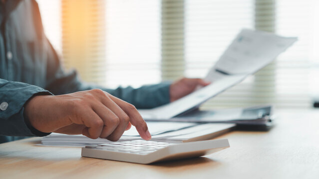 invoice, billing, accounting, Business professional calculating invoice and reviewing financial documents at office desk, representing billing, payment, accounting, budgeting and expense management.