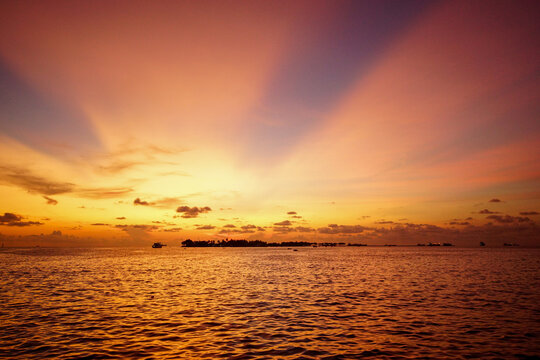 Golden tropical sunset over the sea with island and ships, Makassar, Sulawesi, Indonesia