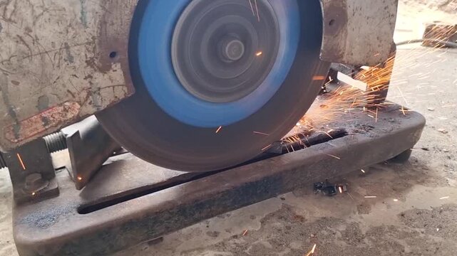 Close up of angle grinder cutting iron pipe, rotating abrasive disc in motion, handheld power tool used for masonry and construction work outdoors. Slow motion Footage. Beautiful 4k Footage.