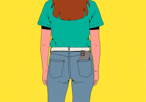Rear view of young woman with smart phone in back pocket of jeans against yellow background