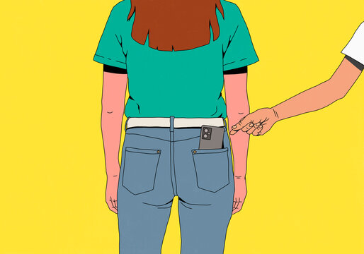 Hand reaching for smart phone in back pocket of woman's jeans against yellow background