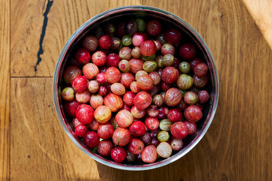 Still life view from above of fresh gooseberries in bowl
