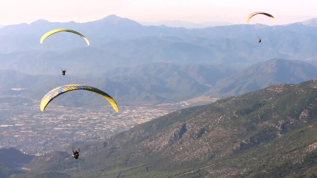 Paragliding above Fethiye combines mountain air and blue sea in Turkey.