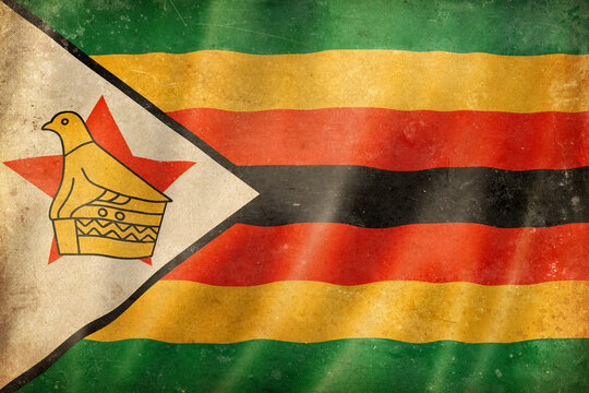 Old vintage flag of Zimbabwe, worn and stained