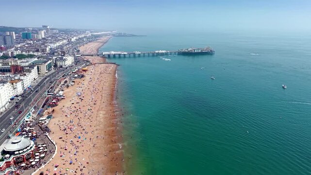Aerial view of the cityscape and beachfront of Brighton, England, during a calm and sunny day