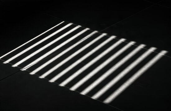 Stark light stripes cast diagonal shadows across a dark, tiled surface
