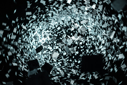 Swirling blizzard of torn paper fragments in the dark, information chaos concept