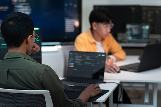 Software Developers Collaborating on Computer Code in Modern Office.