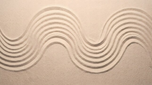 Overhead view of rhythmic wavy pattern raked into clean beige sand creating harmonious zen garden texture for tranquil spa background