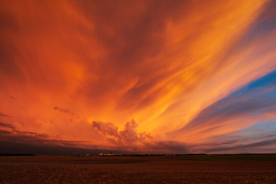 Sunset sky with dramatic orange clouds over rural Winner, south dakota