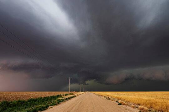 Developing Supercell storm over county dirt road in tribune, kansas