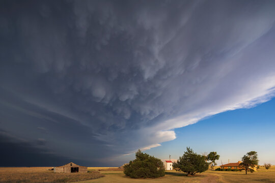 Storm clouds approaching homestead near johnson city kansas USA