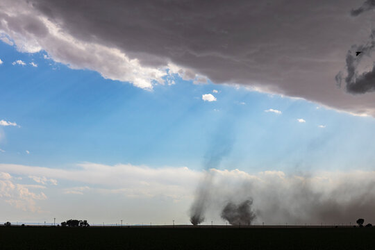 Twin tornadoes forming on county road 2 near fowler, colorado