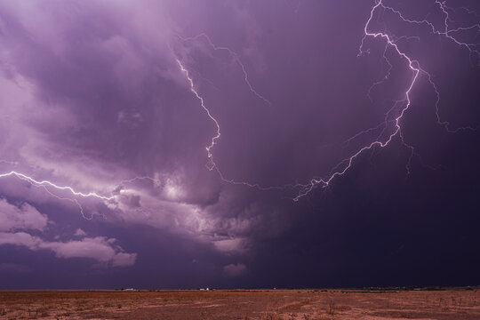Lightning illuminates thunderstorm over dry open land in colorado, USA