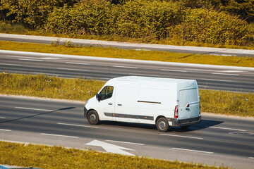 Unbranded white van on countryside road © AlexGo