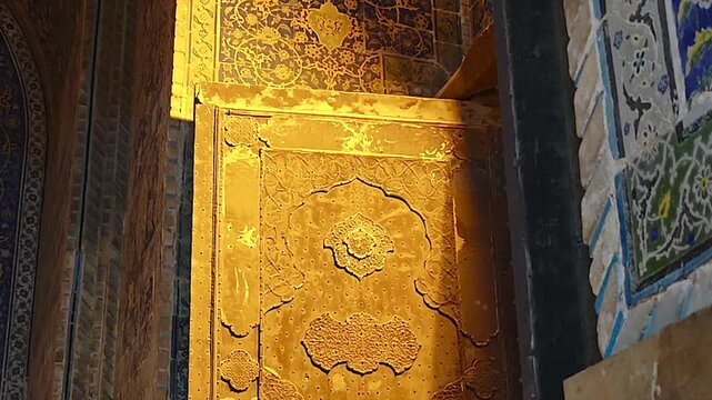 Shah Abbas Mosque wall and doorway ornament display tilework and golden Islamic detail.