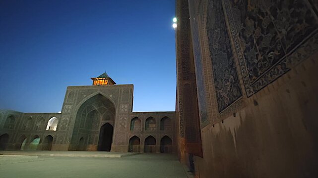 Shah Abbas Mosque courtyard stands empty at night with tiled walls and calm sacred space.