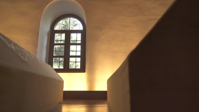Cloth covered caskets rest inside Islamic tomb, sacred interior reflecting spiritual mourning.