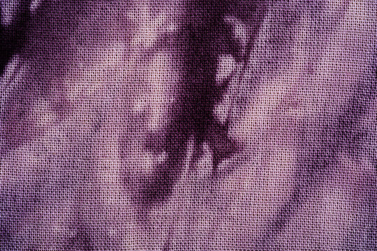 Close up macro view of purple tie dye fabric texture