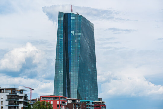 FRANKFURT AM MAIN, GERMANY - JULY 27, 2025: Modern glass tower of the European Central Bank (ECB) building against a cloudy sky in the Ostend district.