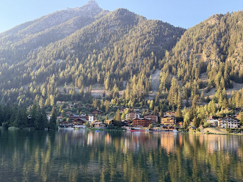 a mountain range in the background with trees and houses on it
